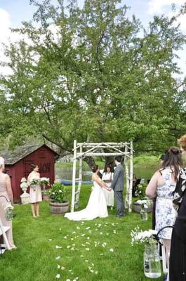 Marry your beloved beneath a tree and arbor, with the water behind you, and a sign of JOY posted for all to see.