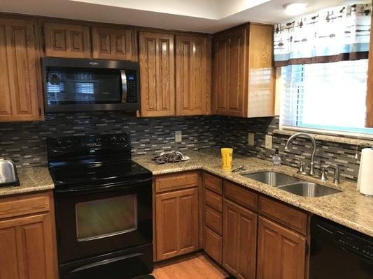 Countertops, backsplash, sink, and oven hood/microwave combo all done by ACRECO