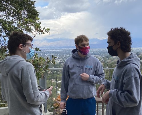 Students reconnect on campus during a socially distance get together.