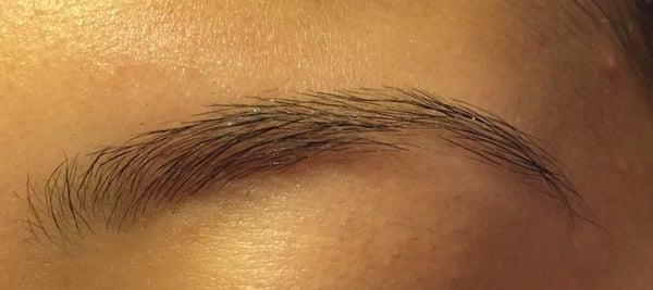 Uneven & botched. She left a hole in the middle of my eyebrows. They are thin & scraggly.  BEWARE.