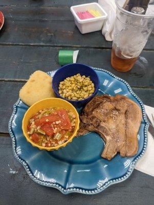 Baked pork chop, fresh okra and tomatoes, and fresh field peas.