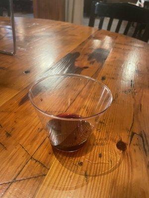 Wine in a plastic cup. No glasses available