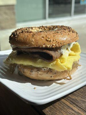 Steak and egg sandwich on an everything bagel, with shaved steak.