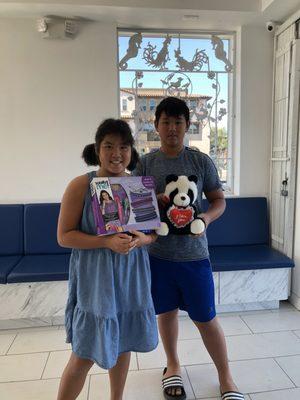 Siblings showing their appreciation gifts after getting their annual physicals.