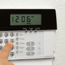 Woman disarming a home alarm