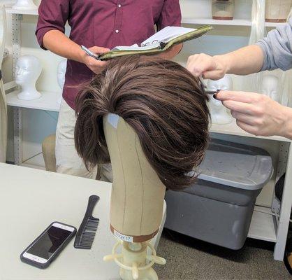 A wig class in progress, showing layering and care.