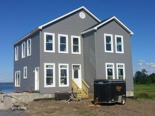 Two story modular with lineal trim around windows. 9' ceiling and transom windows first floor