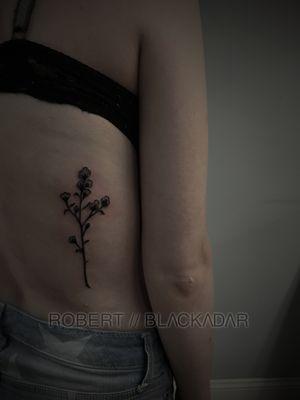 Flower on the back of the ribs by Robert