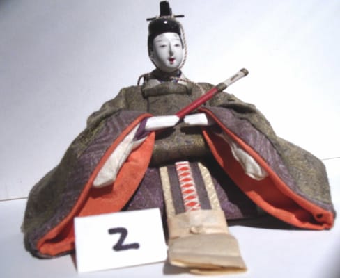 Antique Japanese doll dressed in rich brocade fabrics.