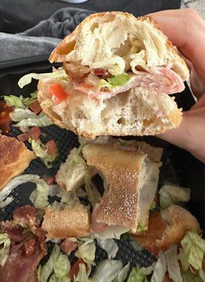 Not sub bread and most of the sandwich is on the outside of the sandwich.