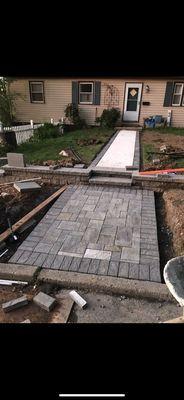 Progress shot of new concrete walkway, EP Henry step Pad with retaining wall.