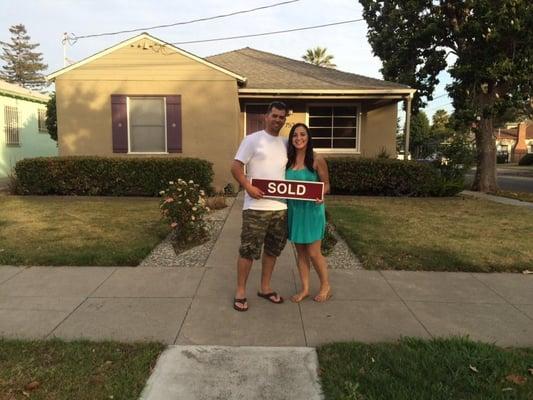 Nelson and Angelina in front of their first home.