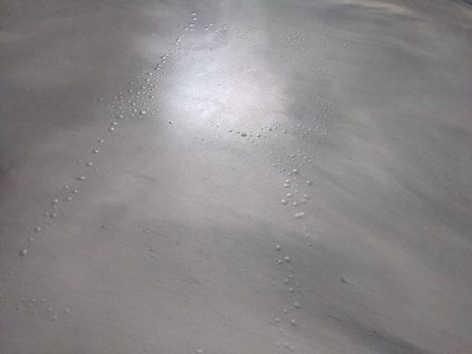 Epoxy coating, metallic matte with excessive blistering/bubbles due to incorrect prep of the concrete