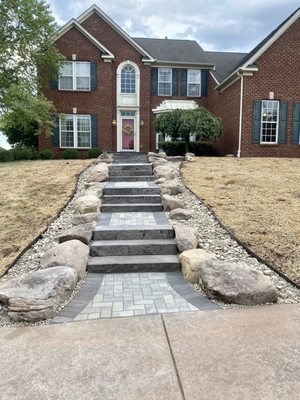 Staircase with landings using pavers, boulders, and techo bloc treads