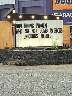 Rude sign stating, "Now hiring women who are not dumb as rocks. Unicorns needed."