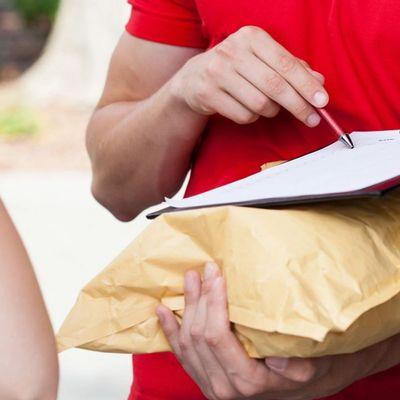 Man holding a package and pen