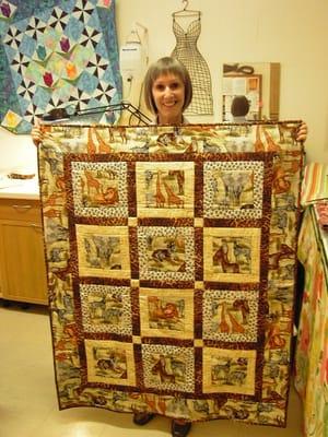 Julie J. and the quilt she made for her grandson.