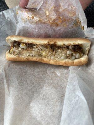 Chili dog with mustard and onions.