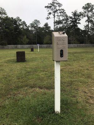 Poop bag and trash cans within the park