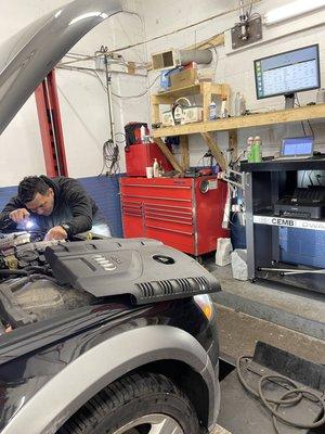 Manuel working on a engine