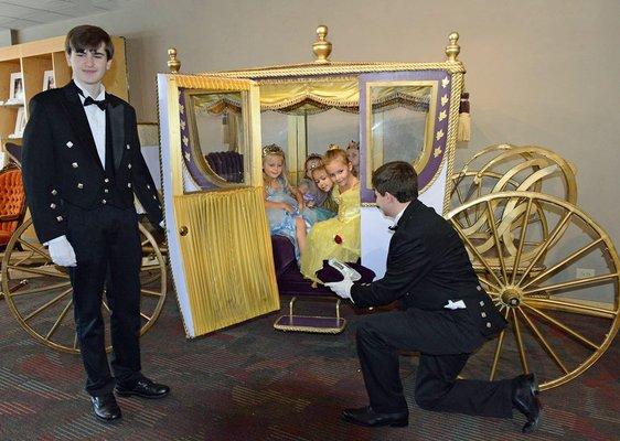 The Museum - Prince Charming offers a glass slipper at the Museum's Princess Party