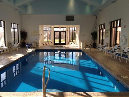 Swimming pool with a hot tub jacuzzi.