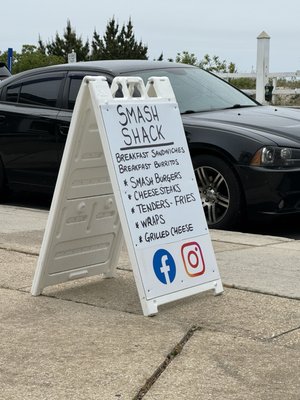 Smash shack's sign on the sidewalk