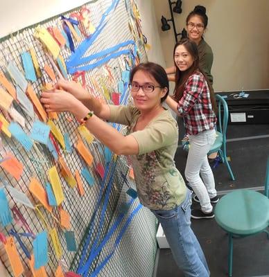 Volunteers of all ages came to the Senior Center on three consecutive Saturdays to laminate, hole punch, and attach poems to plastic fence.