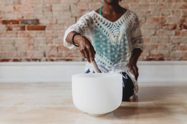 Playing a crystal singing bowl