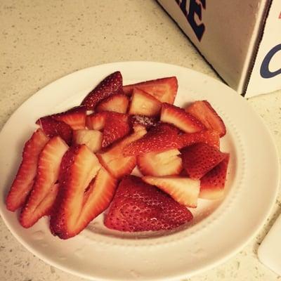 sliced strawberries with a little sugar on top