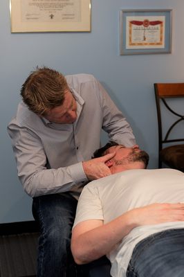 Dr. Brian helping a patient with neck pain