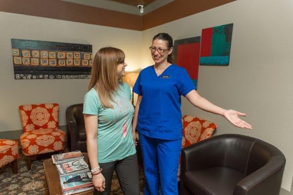 A client being greeted before an appointment by one of our student massage therapists