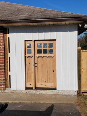 Door installed and Azek board and battens installed