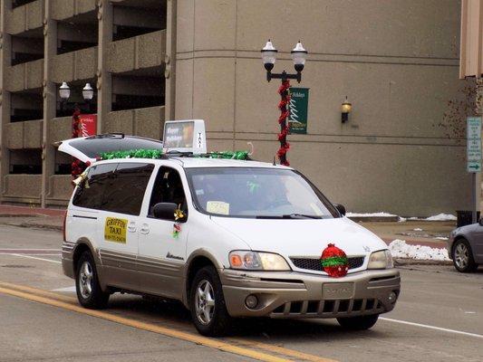 Our partner taxi company during the 2018 holiday parade in Saginaw MI, with our LED car sign!