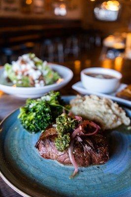 Saloon Steak with grilled or blackened flat iron, chimichurri, pickled red onion, roasted vegetables & mashed potatoes