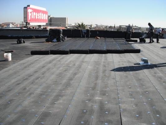 In this photo we are installing the new roof system. For this job we installed a Firestone brand rubber roof on a Firestone s...