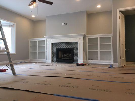 Custom built ins with a new mantel and glass tile.