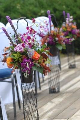 baskets lining the wedding aisle, became reception centerpieces afterwards