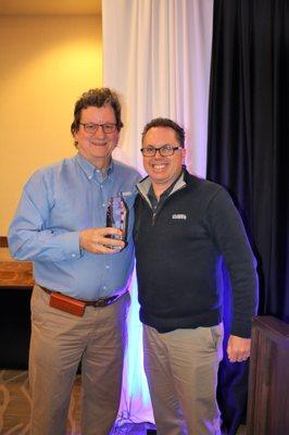 Agent Ed Rector receiving a sales award March 2018 from Broker Clark Segerstrom at our banquet luncheon!