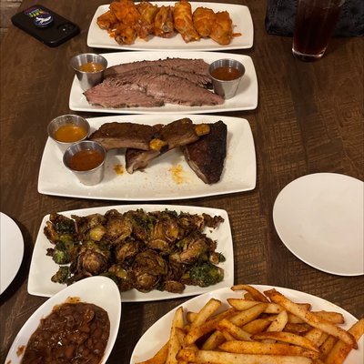 Fries, baked beans (the best), Brussels sprouts, ribs, brisket, and wings. A true feast