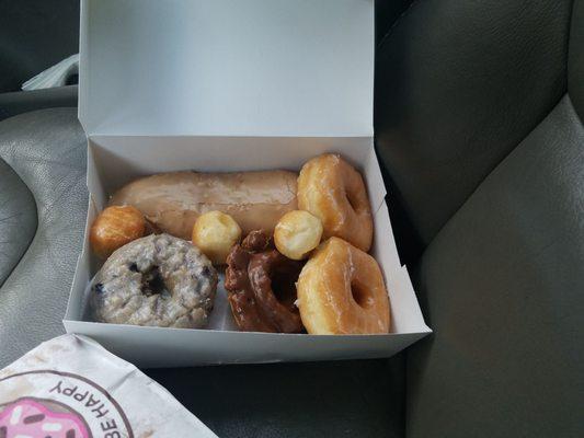 Clockwise: Maple Long John, Two Glazed, Chocolate Old-fashioned, Blueberry Cake (plus three bonus donut holes)