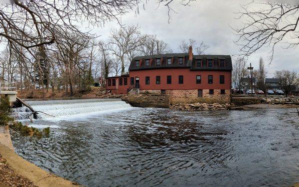 Waterfall and historic red building