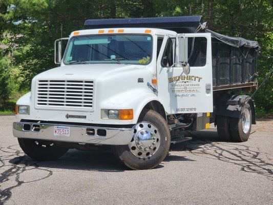 nice looking clean dumpster and truck