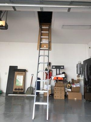 Aluminum attic ladder installation in the garage