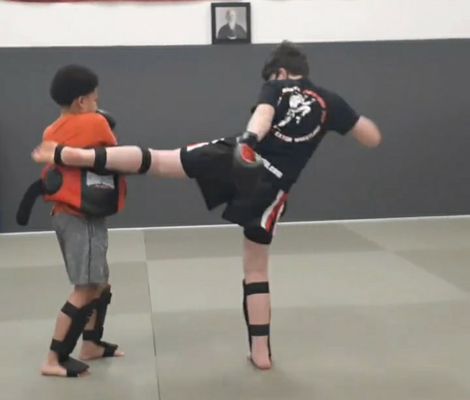 Youth Muay Thai class practicing body kicks!!