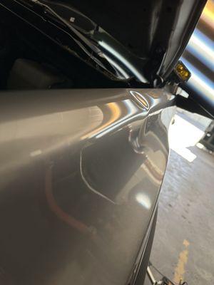 Deep dent in a Toyota Tacoma driver fender