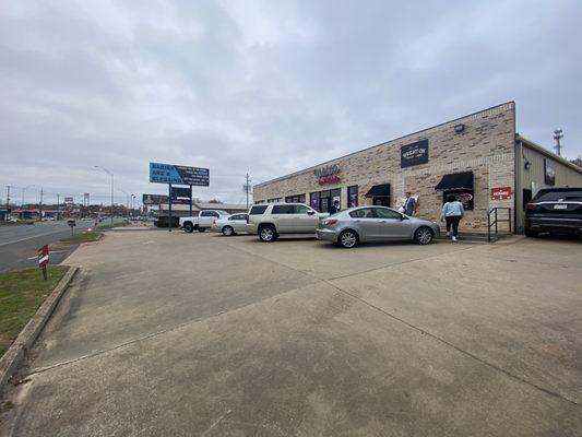 Tight parking. The entrance is to the far right, in the drive thru lane.  Walk up windows in front.