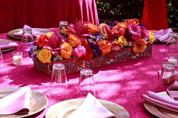 Bright orange, pinks, and yellow wedding centerpieces