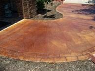 Custom rust stained patio walkway before landscaping.