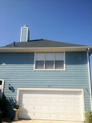 Green GAF HD shingles. Chimney has hail damage and is freshly painted.